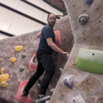 man in a dating event climbing rocks